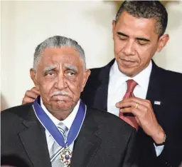  ?? J. SCOTT APPLEWHITE/AP ?? President Barack Obama presents the Presidenti­al Medal of Freedom to the Rev. Joseph E. Lowery on Aug. 12, 2009.