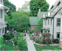  ?? JOANNA VANDER PLAATS/FOR THE ASSOCIATED PRESS ?? The Newberry Place co-housing community in Grand Rapids, Mich., was designed to be pedestrian-friendly, with parking out of view. Similar to condo fees, residents pay into a fund for the upkeep of common areas.