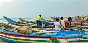  ?? PTI ?? Fishermen park their boats on the shore after reports of formation of a low pressure area in the Andaman sea