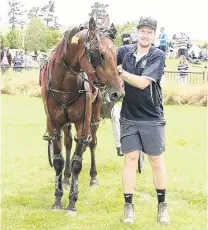  ?? PHOTO: MONICA TORETTO ?? Winton teacher Jamie Campbell holds Mickey Fitz at the Cromwell track yesterday after notching his first win as a trainer.