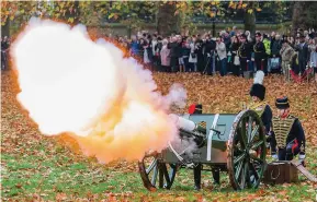  ?? ?? Majestic...King’s official photo, above, & gun salute in Green Park, London