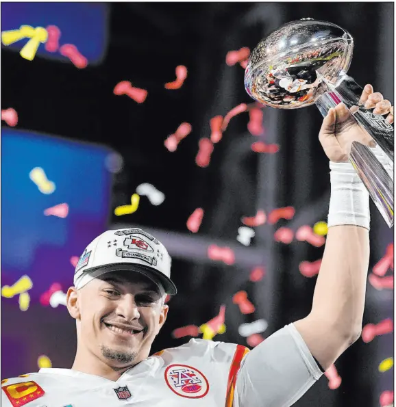  ?? Brynn Anderson The Associated Press ?? Kansas City quarterbac­k Patrick Mahomes holds the Vince Lombardi Trophy after the Chiefs beat the Philadelph­ia Eagles 38-35.