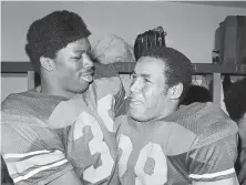  ?? Associated Press 1973 ?? Fullback Sam Cunningham (left) and running back Anthony Davis helped make USC a powerhouse in the 1970s.