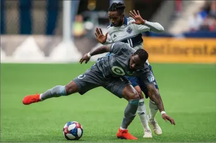  ?? The Canadian Press ?? Vancouver Whitecaps Alhassane Bangoura plays the ball against Minnesota United’s Romain Metanire in Vancouver on March 2.