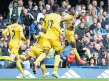  ?? Picture: GETTY IMAGES ?? JUMP FOR JOY: Wilfried Zaha of Crystal Palace, right, celebrates scoring his side’s first goal against Chelsea at Stamford Bridge