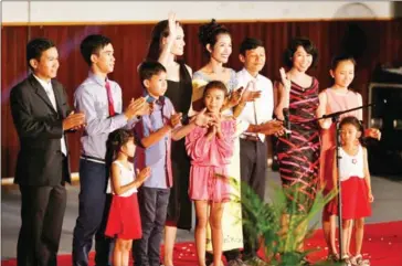  ??  ?? Angelina Jolie and some of the cast of premiere at the Olympic Stadium in Phnom Penh on Tuesday. wave during a press conference at the film’s