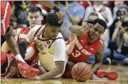  ?? DARRON CUMMINGS / AP ?? Indiana’s Juwan Morgan (middle) battles for the ball against Ohio State’s Kyle Young (left) and C.J. Jackson during the first half of their game Sunday in Bloomingto­n, Ind.