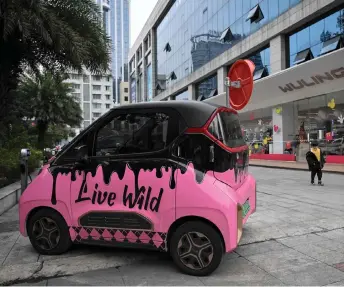  ?? — AFP photo by Jade Gao ?? A decorated mini electric vehicle parking outside a store of Chinese automaker Wuling, in Liuzhou, in southern China’s Guangxi province.
