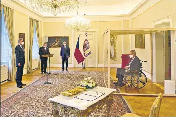  ?? ?? Covid-struck Czech President Milos Zeman, sits in a plastic enclosure as he appoints ODS leader Petr Fiala (left) as Czech Prime Minister at the Lany manor, near Prague, on Sunday.