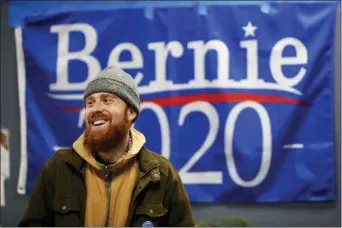  ?? PAUL SANCYA — THE ASSOCIATED PRESS ?? In this March 3, 2020, photo, Jonah Hahn, a supporter of Democratic presidenti­al candidate Sen. Bernie Sanders, I-Vt., watches returns during a Super Tuesday watch party in Ann Arbor, Mich.