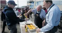  ?? Adrian Wyld/The Canadian Press ?? Northwest Territorie­s Premier Bob McLeod, centre, and Yukon’s Darrell Pasloski, right, take part in Nunavut Day celebratio­ns on Wednesday in Iqaluit, where western premiers have been meeting.