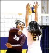  ?? Photo by Mike Eckels ?? Decatur’s Diana Reza knocks the ball back into Lady Pioneer territory after Gentry’s Chastery Fuamatu (20) tries to spike it during a volleyball match in Decatur on Sept. 26.