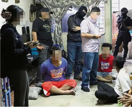  ??  ?? Detained: Counter Terrorism officers arresting three of the seven suspected militants in Kuala Lumpur.