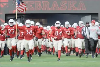  ?? GETTY IMAGES ?? Nebraska players (shown taking the field in 2018) have filed a lawsuit to play football in the fall.