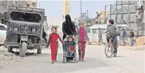  ??  ?? Civilians on the streets of Douma yesterday after all rebels were driven out by Syrian army