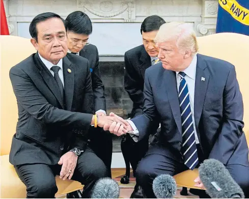  ??  ?? Prime Minister Prayut Chan-o-cha and US President Donald Trump shake hands during a meeting in the White House on Monday in Washington, DC. Once seeking investment funds from the US, Thailand is now the world’s emerging outward investor.