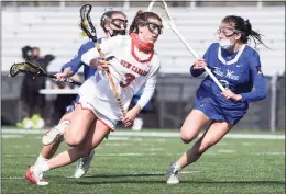  ?? Dave Stewart / Hearst Connecticu­t Media ?? New Canaan’s Dillyn Patten, left, drives to the goal while Darien’s Sam Barlow, right, defends during a game in April.