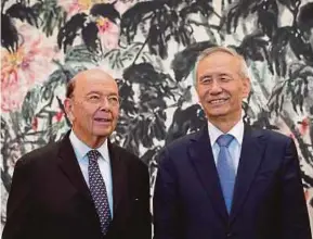  ?? EPA PIC ?? US Commerce Secretary Wilbur Ross (left) with Chinese VicePremie­r Liu He after their meeting in Beijing yesterday.