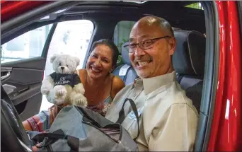  ?? Austin Dave/ The Signal ?? (Above) From left, Lisa Lujano and Dennis Sugasawara check out the 2019 Acura MDX. (Below right) Troy Hooper, SCV Chamber of Commerce chair, says a few words at the dealership Wednesday. (Below left) Valencia Acura co-owners Don and Cheri Fleming hosted the mixer in part to show off the new SUV.