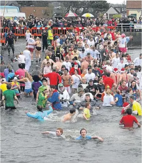  ??  ?? Keen swimmers take part in last year’s New Year’s Day Dook in the Ferry.