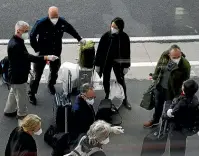  ?? AP ?? Members of a WHO team arrive in Wuhan in central China’s Hubei province as part of an inquiry into the origins of the coronaviru­s.