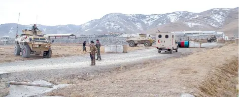  ?? — AFP photo ?? Security personnel are seen after a suicide car bomber struck an army base on the outskirts of Ghazni province.