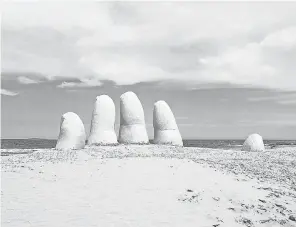  ?? GETTY IMAGES ?? The famous “La Mano” hand sculpture is a symbol of Punta del Este, Uruguay.