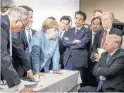  ?? Picture: JESCO DENZEL/BUNDESREGI­ERUNG/GETTY IMAGES ?? HORSE TRADING: Chancellor Angela Merkel deliberate­s with US president Donald Trump on the sidelines of the G7 summit. Also pictured are, from left, US National Economic Council director Larry Kudlow, UK Prime Minister Theresa May (obscured), French...