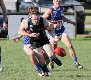  ??  ?? Cora Lynn’s Nathan Gillis is brought to ground by his Bunyip opponent.