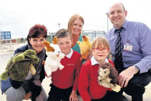  ??  ?? Hendreforg­an Primary School pupils Evan Hughes and Leah Chappell, both seven, with FG leader Karen Hughes, head teacher Kevin Stroud, and Elaine Britton, PATHS Plus Programme Coordinato­r