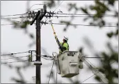  ?? JANE TYSKA — BAY AREA NEWS GROUP ?? A PG&E worker repairs a power line Nov. 1 after a branch fell on Sunkist Drive in Oakland.