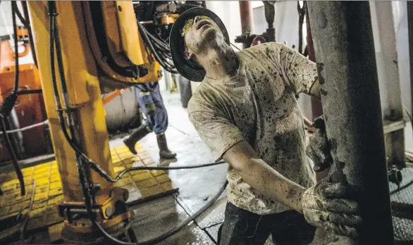  ?? ANDREW BURTON/ GETTY IMAGES FILES ?? A floor hand lines up a pipe while drilling for oil in the Bakken shale formation in North Dakota. The worst slump in a generation has taken a bite out of U.S. shale, but projects in Canada’s oilsands and the Gulf of Mexico are thriving.