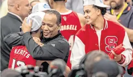  ?? ROBERT WILLETT rwillett@newsobserv­er.com ?? N.C. State coach Kevin Keatts embraces his son K.J. Keatts (13) as they celebrate the Wolfpack’s ACC Tournament Championsh­ip after the team’s 84-76 victory over North Carolina at Capital One Arena on March 16, 2024, in Washington, D.C.