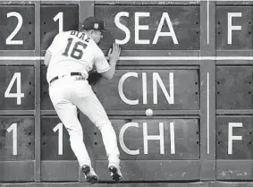  ?? Brett Coomer/Staff photograph­er ?? The Astros’ Aledmys Díaz crashes into the outfield wall after chasing a double by the Rays’ Ji-Man Choi in the seventh inning Saturday at Minute Maid Park.