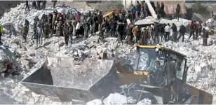  ?? (AP photo/Ghaith Alsayed) ?? Rescuers and residents search Wednesday through the rubble of collapsed buildings in the town of Harem near the Turkish border, Idlib province, Syria.