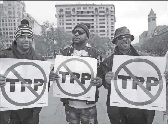  ?? AFP ?? Photo shows men holding signs as they demonstrat­e against the Trans-Pacific Partnershi­p (TPP) trade agreement in Washington, DC.