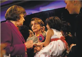  ?? Lea Suzuki / The Chronicle 2014 ?? Sen. Dianne Feinstein, D-Calif. (left), attends a 2014 political luncheon with House Minority Leader Nancy Pelosi, holding granddaugh­ter Bella Kaufman, 5.