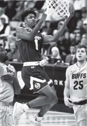  ??  ?? Colorado State’s Devocio Butler drives past Colorado’s Wesley Gordon, left, during the first half Wednesday night at the Coors Events Center. Cliff Grassmick, Daily Camera