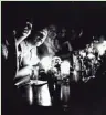  ?? DAVE PICKOFF/ASSOCIATED PRESS ?? People at Chapman's Restaurant in midtown Manhattan continue their drinking by candleligh­t after New York City had a blackout on July 13, 1977.
