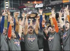  ?? Associated Press ?? The Houston Astros celebrate their 4-1 World Series win against the Philadelph­ia Phillies in Game 6 on Saturday in Houston. The Astros won the series 4-2. It is their second World Series title in six years and Dusty Baker won his first ring as a manager.