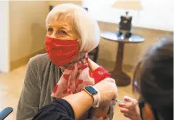  ??  ?? Bev Cullen, 80, receives her second dose of the COVID19 vaccine from nurse Debbie Outcalt at Oakmont of Montecito assisted living facility.