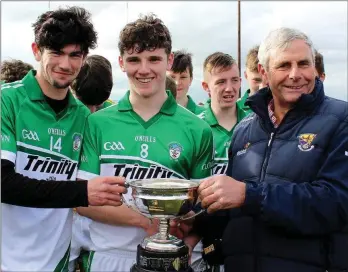  ??  ?? Connal Flood and Billy Wickham, joint captains of Cloughbawn, at the presentati­on of the cup by Bobby Goff, Chairman of Coiste na nOg Loch Garman.