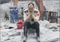  ??  ?? One of the rescue workers who was searching through the rubble left by a landslide that buried the mountain village.