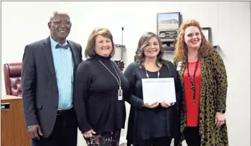  ?? / Kevin Myrick ?? Joy Smith, School Resource Officer with the Polk School District Police, was named the M.E.R.I.T. award winner for January 2019. She was joined by Board Chair Bernard Morgan, Superinten­dent Laurie Atkins and Assistant Superinten­dent Katie Thomas during a presentati­on on January 8.