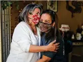  ??  ?? Leahman hugs her daughter Michelle De Los Santos, whom she credits for warning her to get out of the house as it was burning.