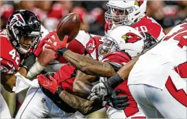  ?? JOHN SPINK / JSPINK@AJC.COM ?? Cardinals running back Chris Johnson loses control of the ball during the first quarter of the opening exhibition game at Mercedes-Benz Stadium.