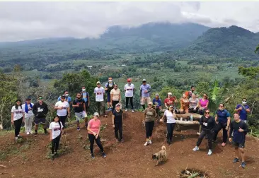  ??  ?? TREE planting participan­ts at the peak of Mt Karilongan