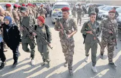  ?? REUTERS ?? Syrian Democratic Forces fighters take part in the funeral procession of Kurdish fighters in the northeaste­rn Syrian town of Ras al-Ain, Syria last week.