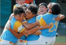  ?? GENE J. PUSKAR — THE ASSOCIATED PRESS ?? Honolulu, Hawaii pitcher Ka’olu Holt, center, begins to celebrate with Sean Yamaguchi , left, and Aukai Kea (23) after pitching a complete game, 3-0 shutout in the Little League World Series Championsh­ip baseball game against South Korea in South Williamspo­rt, Pa., Sunday.