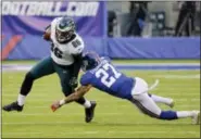  ?? SETH WENIG — THE ASSOCIATED PRESS ?? Philadelph­ia Eagles tight end Zach Ertz (86) avoids the tackle attempt of New York Giants free safety Darian Thompson (27) during the second half of an NFL football game Sunday in East Rutherford, N.J.